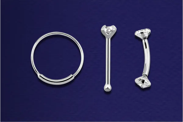 Three different types of piercing jewellery made of white gold