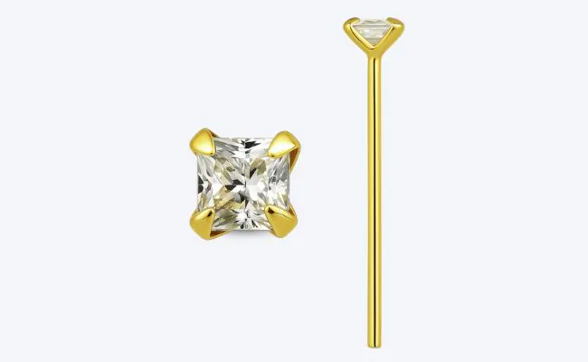 A gold bend-it-yourself nose stud with a prong set transparent crystal top