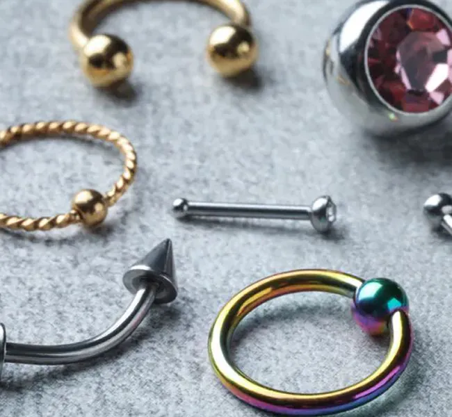 Various types of piercing jewelry in different materials and shapes