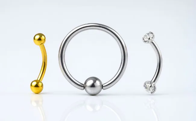 Three different types of eyebrow piercing jewellery