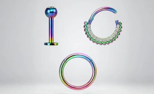 Three kinds of anodised body jewellery in rainbow colours