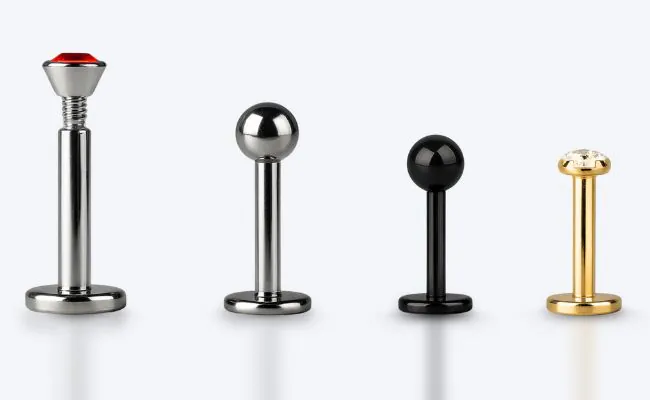Four pieces of labret jewellery in different designs and materials for medusa piercings