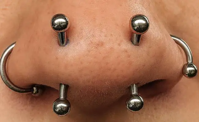 Closeup of a nose with Multiple nose piercings