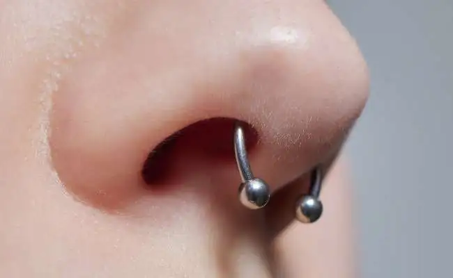 Closeup of a nose featuring a septum piercing