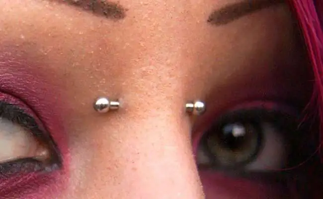 Closeup of a nose featuring a nose bridge piercing