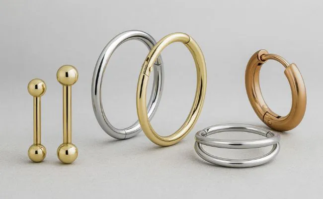 Different types of gold piercing jewellery in yellow, white and red gold